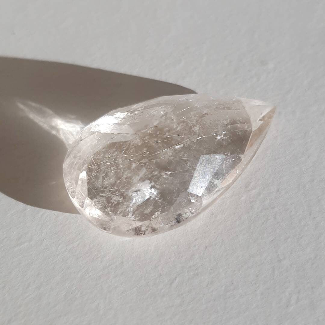 Faceted teardrop golden rutile gem